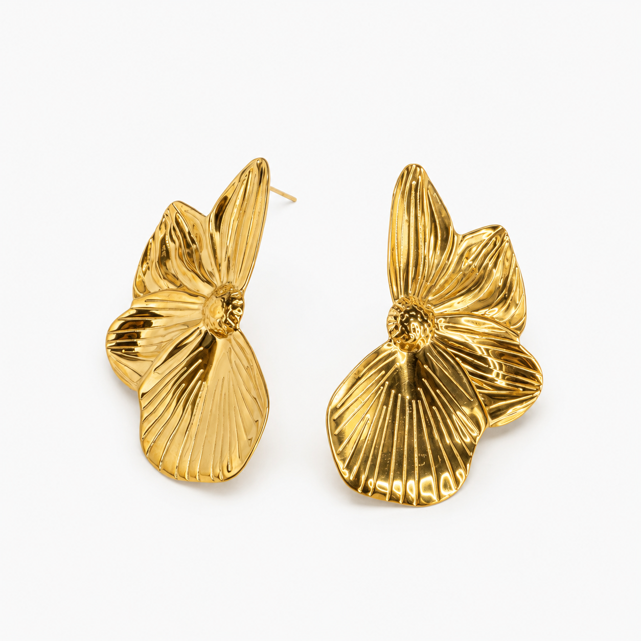A pair of gold-tone flower-shaped stud earrings with textured, ribbed petals, displayed on a clean white background.