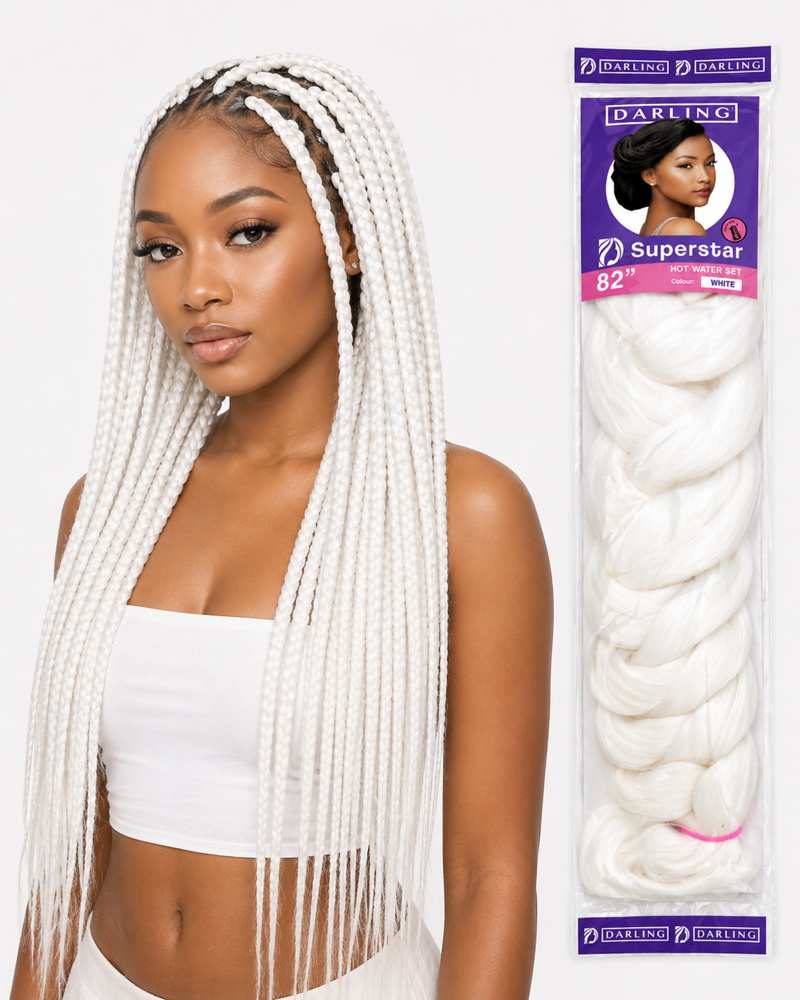 A woman modeling long white box braids next to the retail packaging of Darling Hair Extensions Superstar 82" white hair extension bundle.