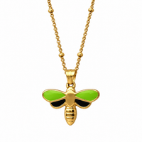 Gold bee pendant necklace with bright green wings and black accents, shown on a white background.