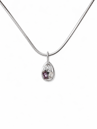 Close-up of the silver Iris teardrop pendant necklace featuring a cluster of clear and purple crystals on a sleek snake chain.